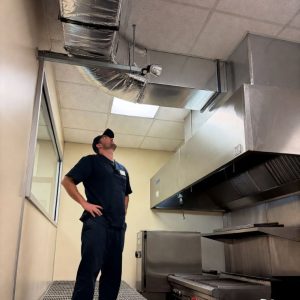 HVAC technician inspecting ductwork